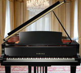 A polished black Yamaha C1X grand piano, placed in an elegant room with a luxurious interior.