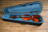 A Sandner RV-1 student violin outfit with a violin and bow placed inside an open blue violin case.